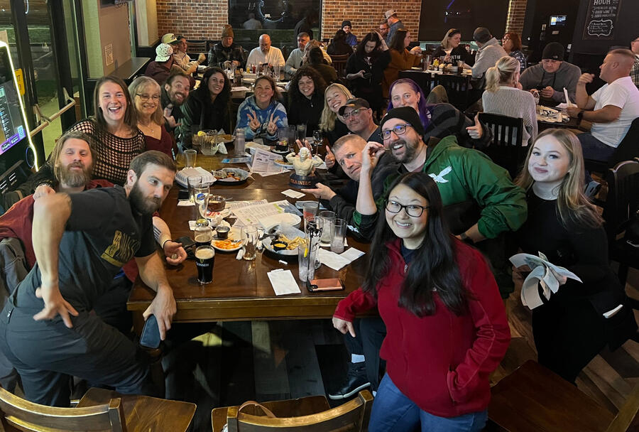 Large group enjoying AbsoLOUte Trivia night hosted by DJ Lou DiMarco at a House of Brews in Turnersville, with players from Crosskeys Skydiveing gathered around tables, laughing, playing trivia, and having drinks during a live event.